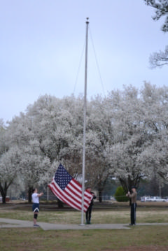 The Executive Staff prepares to raise the colors