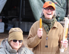 Support staff in front of mess tent preparing a meal. 