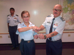 Capt Ron Watkins presents Cadet Cameron Albert with her ribbon upon her promotion to C/SrA