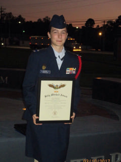 Female cadet with award