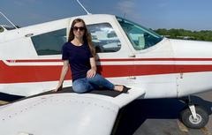 female cadet sits on wing