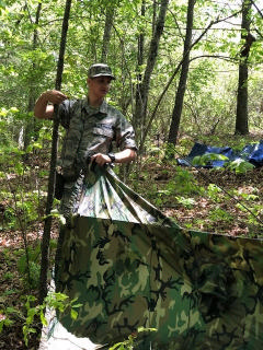 cadet erecting woodland shelter
