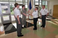 Capt Hallihan hands over flag