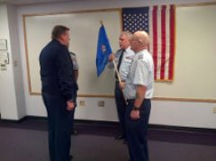 Col Toby Wall (left) receives the Squadron guidon from Capt Pete Wehr at the February 5, 2015 Change-in-Command ceremony.