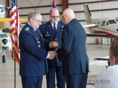 Col Larry Ragland, Civil Air Patrol National Executive Officer presents Lt Col Clive Goodwin, Jr., the bronze replica of the Congressional Gold Medal as Col David Crawford; CAP NC Wing Commander looks on. 