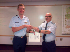 C/CMSgt Daniel Ham receives the Cadet of the Quarter Award Certificate and coin from Capt Ron Watkins
