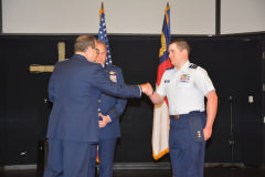 Capt Willis presenting custom engraved Spaatz coin to C/Col Waters as Gen Scanlan looks on.