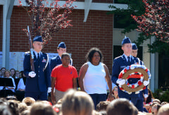 The color guard escorts Mrs. Monique Onwardi and her son