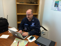 Col Dave Crawford, Planning Section Chief reviewing task and sortie information.