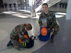 C/SrA Lindsey Brooks and C/2dLt Hazen David Ham add MRE’s to their field packs on January 17, 2015, prior to being dispatched with Ground Team 9.