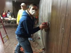 Cadet Justin Weinberg sands the paneling to prepare it for painting.