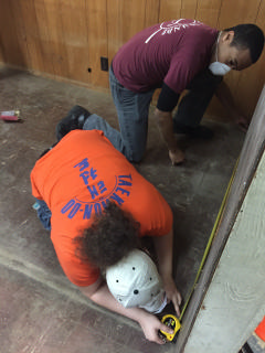 Members Measuring:  SM Justina Hauss and C/A1C Lelyand Cathey take measurements for cutting wood to patch the wall.  